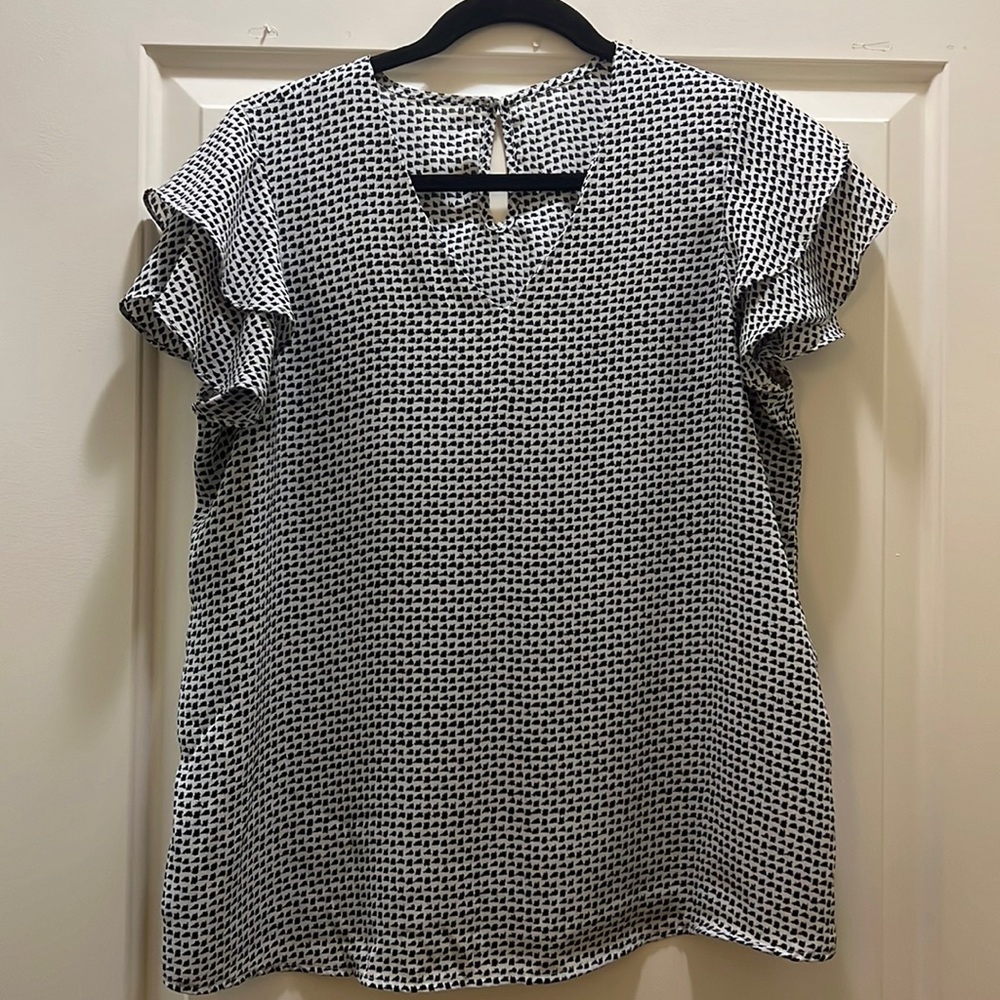 This is a CeCe white and black blouse. With ruffle short sleeves